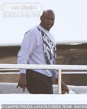 The legendary guard, who changed into a 'Jordan' sweatshirt, relaxed onboard