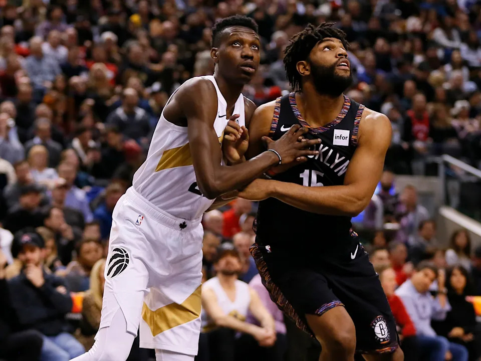Jan 11, 2019; Toronto, Ontario, CAN; Toronto Raptors forward Chris Boucher (25) and Brooklyn Nets forward Alan Williams (15) battle for position at Scotiabank Arena. Mandatory Credit: John E. Sokolowski-USA TODAY Sports