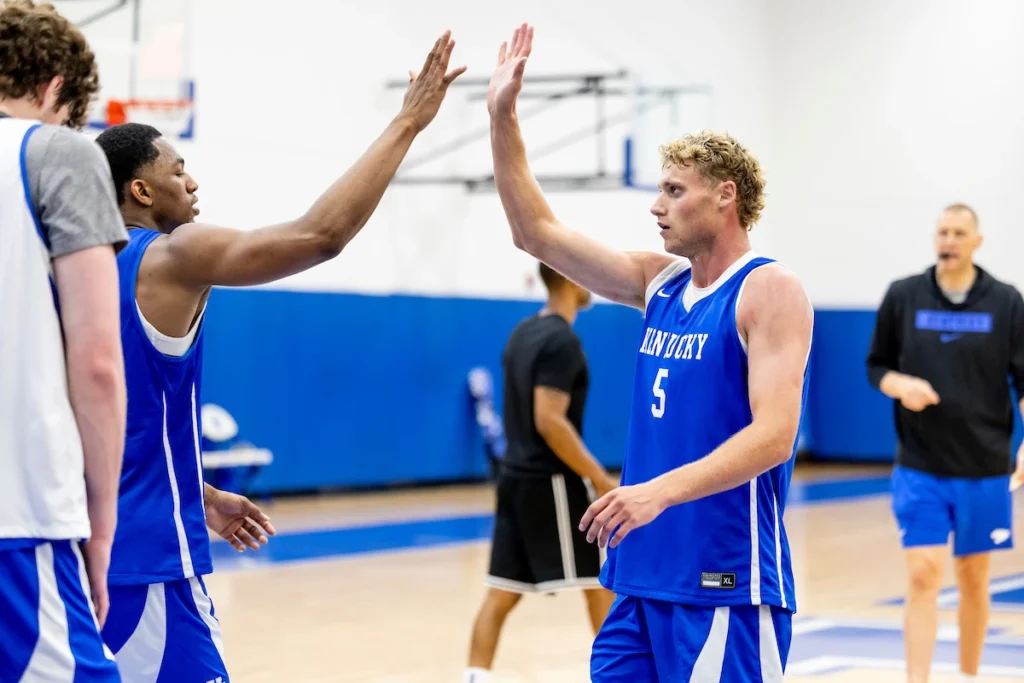 Collin Chandler high fives Mo Dioubate at a Kentucky summer practice - Photo by Chet White, UK Athletics