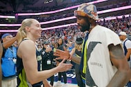 Dallas Wings guard Paige Bueckers (5) gets a high-five from Dallas Mavericks' Kyrie Irving...