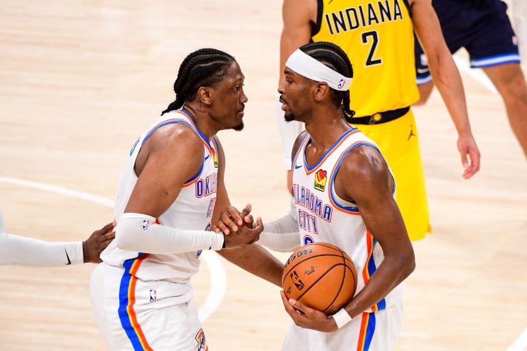 OKLAHOMA CITY, OK - JUNE 16: Jalen Williams #8 and Shai Gilgeous-Alexander #2 of the Oklahoma City Thunder high five during the game against the Indiana Pacers during Game Five of the 2025 NBA Finals on June 16, 2025 at Paycom Center in Oklahoma City, Oklahoma. NOTE TO USER: User expressly acknowledges and agrees that, by downloading and or using this photograph, User is consenting to the terms and conditions of the Getty Images License Agreement. Mandatory Copyright Notice: Copyright 2025 NBAE Adam Pantozzi/NBAE via Getty Images/AFP (Photo by Adam Pantozzi / NBAE / Getty Images / Getty Images via AFP)