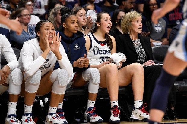 UConn's Caroline Ducharme calls out to her team while a bag of ice is applied to her head during the second half of an NCAA college basketball game against Villanova in the finals of the Big East Conference tournament Monday, March 6, 2023, in Uncasville, Conn. (AP Photo/Jessica Hill)