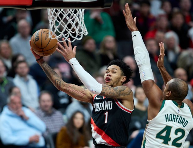 Portland Trail Blazers guard Anfernee Simons shoots over Boston Celtics center Al Horford (42) during the second half of an NBA basketball game in Portland, Ore., Monday, March 11, 2024. (AP Photo/Craig Mitchelldyer)