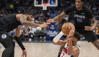 Detroit Pistons forward Troy Brown Jr. (7) looks to pass the ball as Dallas Mavericks guard Jaden Hardy, left, and forward Olivier-Maxence Prosper (18) defend during the second half of an NBA basketball game Friday, April 12, 2024, in Dallas. (AP Photo/Jeffrey McWhorter)