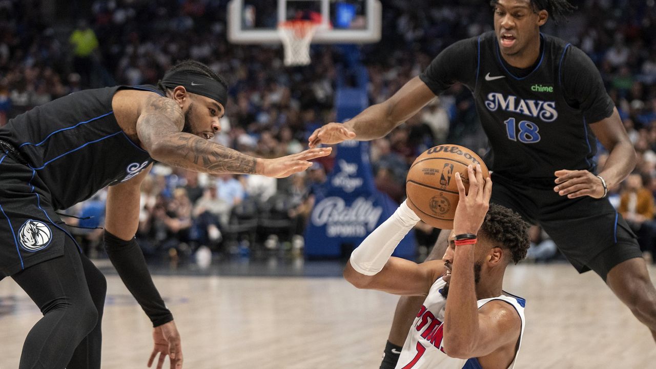 Detroit Pistons forward Troy Brown Jr. (7) looks to pass the ball as Dallas Mavericks guard Jaden Hardy, left, and forward Olivier-Maxence Prosper (18) defend during the second half of an NBA basketball game Friday, April 12, 2024, in Dallas. (AP Photo/Jeffrey McWhorter)