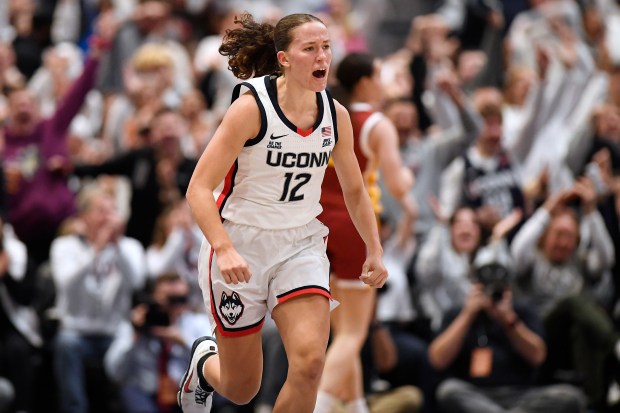 UConn guard Ashlynn Shade (12) reacts in the second half of an NCAA college basketball game against Southern California, Saturday, Dec. 21, 2024, in Hartford, Conn. (AP Photo/Jessica Hill)