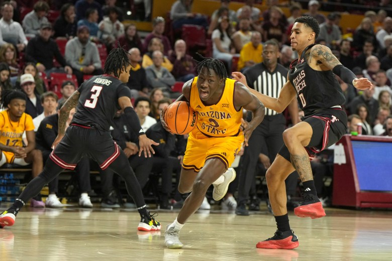 Arizona State guard Joson Sanon drives between Texas Tech guards Elijah Hawkins and Chance McMillian during the second half of an NCAA college basketball game, Saturday, March 8, 2025, in Tempe, Ariz. (AP Photo/Rick Scuteri)
