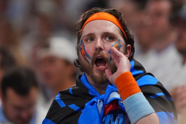 A fan cheers during the first half of Game 1...
