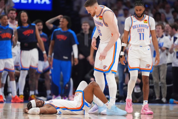 Oklahoma City Thunder guard Shai Gilgeous-Alexander, left, reacts after a...