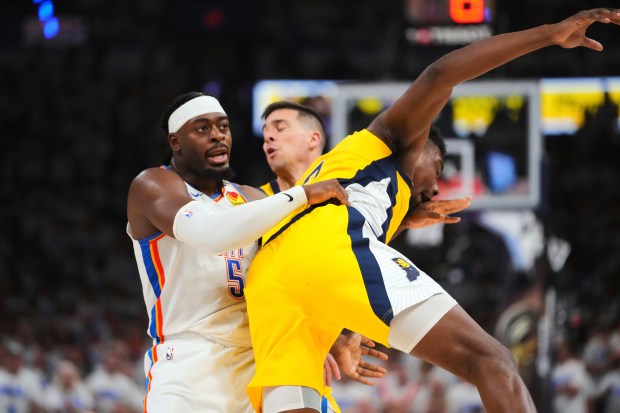 Oklahoma City Thunder guard Luguentz Dort, left, fouls Indiana Pacers...