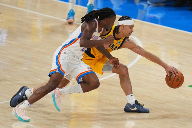 Oklahoma City Thunder guard Cason Wallace, left, and Indiana Pacers...