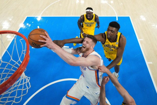 Oklahoma City Thunder center Isaiah Hartenstein, center, drives to the...