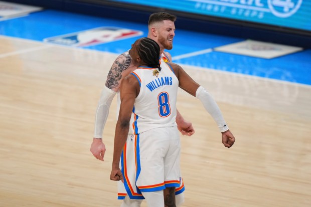 Oklahoma City Thunder forward Jalen Williams (8) celebrateswith center Isaiah...