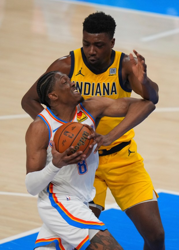 Indiana Pacers center Thomas Bryant, top, defends agaisnt Oklahoma City...