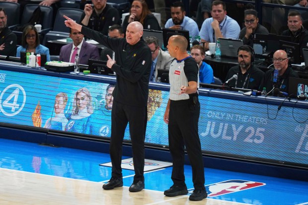 Indiana Pacers head coach Rick Carlisle, left, talks with referee...