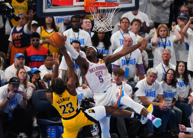 Oklahoma City Thunder guard Luguentz Dort (5) blocks a shot...