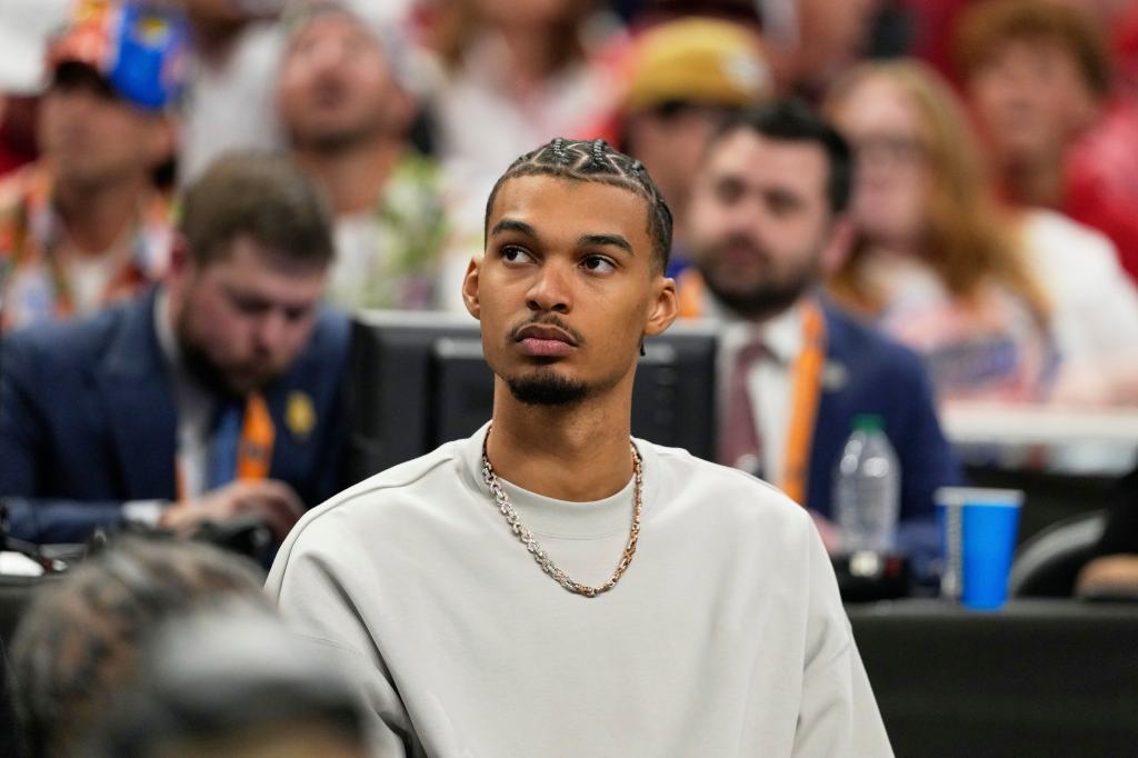 
San Antonio Spurs' Victor Wembanyama watches Florida and Houston during the second half in the national championship at the Final Four of the NCAA college basketball tournament, Monday, April 7, 2025, in San Antonio. 