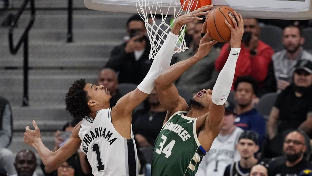 Milwaukee Bucks forward Giannis Antetokounmpo (34) is blocked by San Antonio Spurs center Victor Wembanyama (1) during the first half of an NBA basketball game in San Antonio, Friday, Jan. 31, 2025. (AP Photo/Eric Gay)