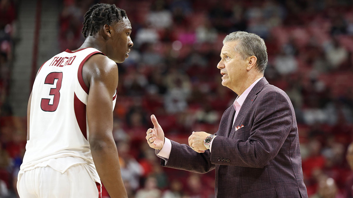 Nov 22, 2024; Fayetteville, Arkansas, USA; Arkansas Razorbacks head coach John Calipari talks to forward Adou Thiero (3) during the second half against the Little Rock Trojans at Bud Walton Arena. Arkansas won 79-67. Mandatory Credit: Nelson Chenault-Imagn Images
