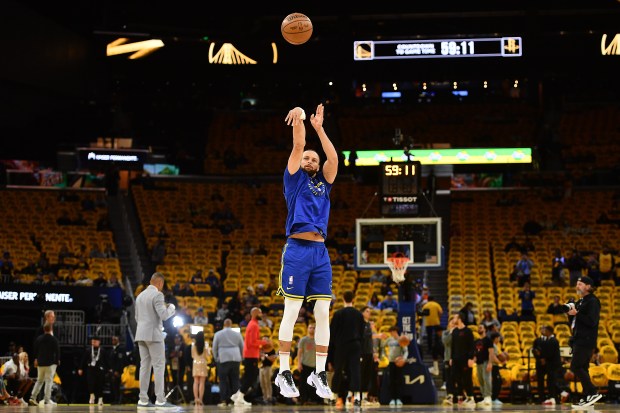 Golden State Warriors' Stephen Curry (30) hangs on the basket while warming up before the start of Game 3 of the Western Conference First Round NBA Playoffs game at Chase Center in San Francisco, Calif., on Saturday, April 26, 2025. (Jose Carlos Fajardo/Bay Area News Group)