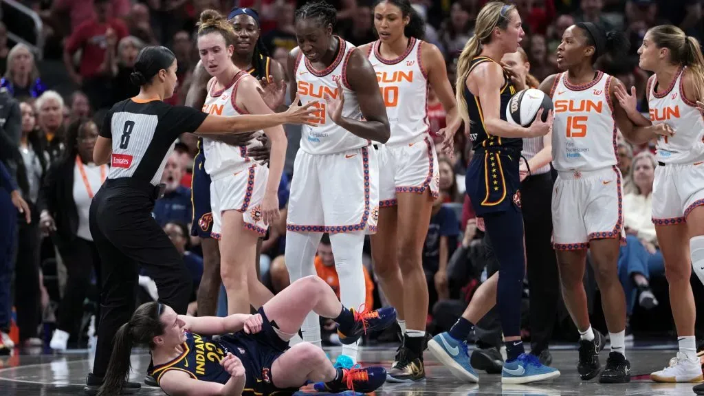 Caitlin Clark #22 of the Indiana Fever falls to the floor after being pushed by Marina Mabrey #3 of the Connecticut Sun (Dylan Buell/Getty Images)