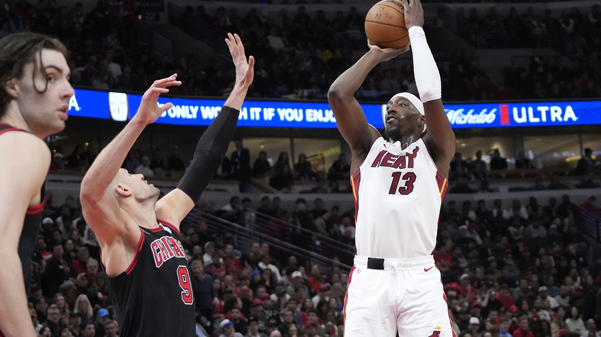 Chicago Bulls center Nikola Vucevic (9) defends Miami Heat center Bam Adebayo (13) during the second half at United Center.