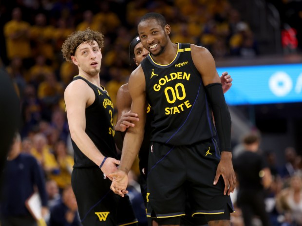 Golden State Warriors' Jonathan Kuminga #00 is congratulated by teammate Brandin Podziemski #2 after he was fouled while making a basket in the second quarter of their NBA Western Conference semifinal game against the Minnesota Timberwolves at the Chase Center in San Francisco, Calif., on Monday, May 12, 2025. (Jane Tyska/Bay Area News Group)