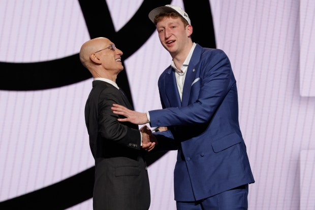 Danny Wolf shakes hands with NBA Commissioner Adam Silver after the Brooklyn Nets selected him at No. 27 on Wednesday, June 25, 2025, in New York. (AP Photo/Adam Hunger)