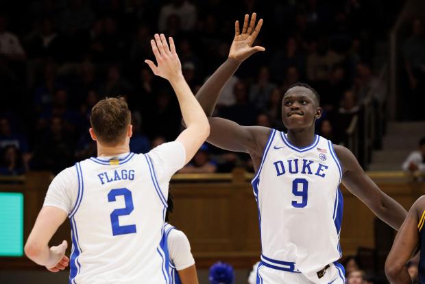 Duke's Khaman Maluach (9) and Cooper Flagg high-five after a play against California on Feb. 12, 2025, in Durham, N.C. (AP Photo/Ben McKeown)