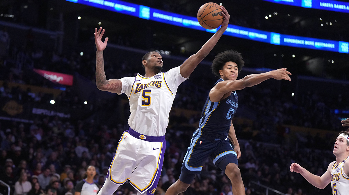 Los Angeles Lakers forward Cam Reddish (5) and Memphis Grizzlies forward Jaylen Wells (0) reach for the ball in the second half at Crypto.com Arena. 