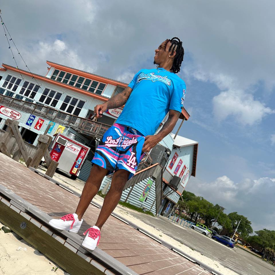 Man wearing Los Angeles-themed shirt and shorts.