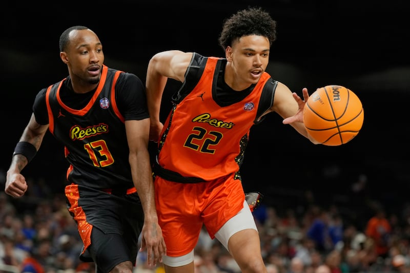 West's Kobe Sanders (22), of Nevada, reaches for a loose ball in front of East's Tamar Bates (13), of Missouri, during college all-star game at the Final Four of the NCAA college basketball tournament, Friday, April 4, 2025, in San Antonio.