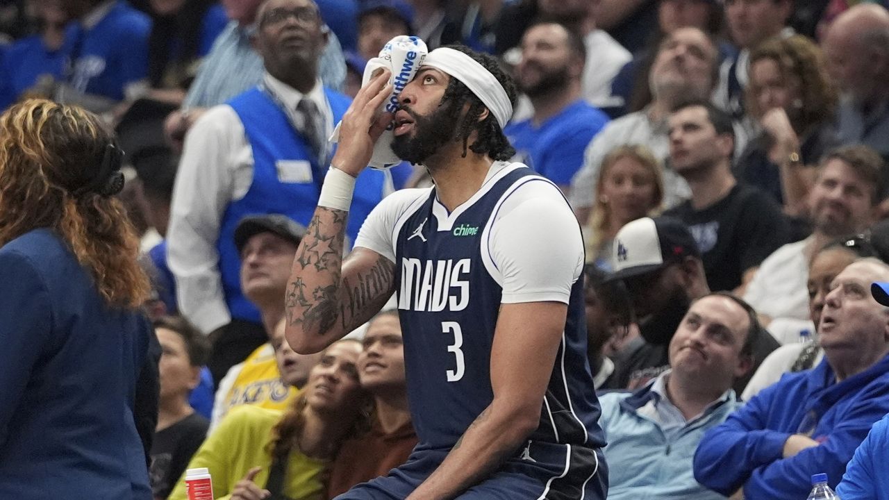 Dallas Mavericks forward Anthony Davis sits after getting inured during the first half of an NBA basketball game against the Atlanta Hawks in Dallas, Wednesday, April 2, 2025. (AP Photo/LM Otero)