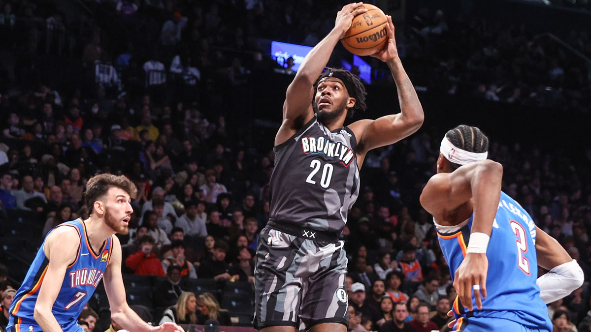 Feb 26, 2025; Brooklyn, New York, USA; Brooklyn Nets center Day'Ron Sharpe (20) looks to drive past Oklahoma City Thunder forward Chet Holmgren (7) and guard Shai Gilgeous-Alexander (2) in the third quarter at Barclays Center. Mandatory Credit: Wendell Cruz-Imagn Images