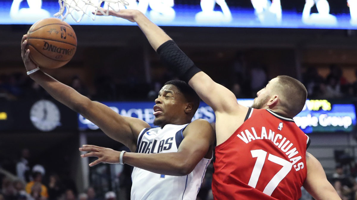 Dallas Mavericks guard Dennis Smith Jr. (1) shoots past Toronto Raptors center Jonas Valanciunas (17) during the first half at American Airlines Center.