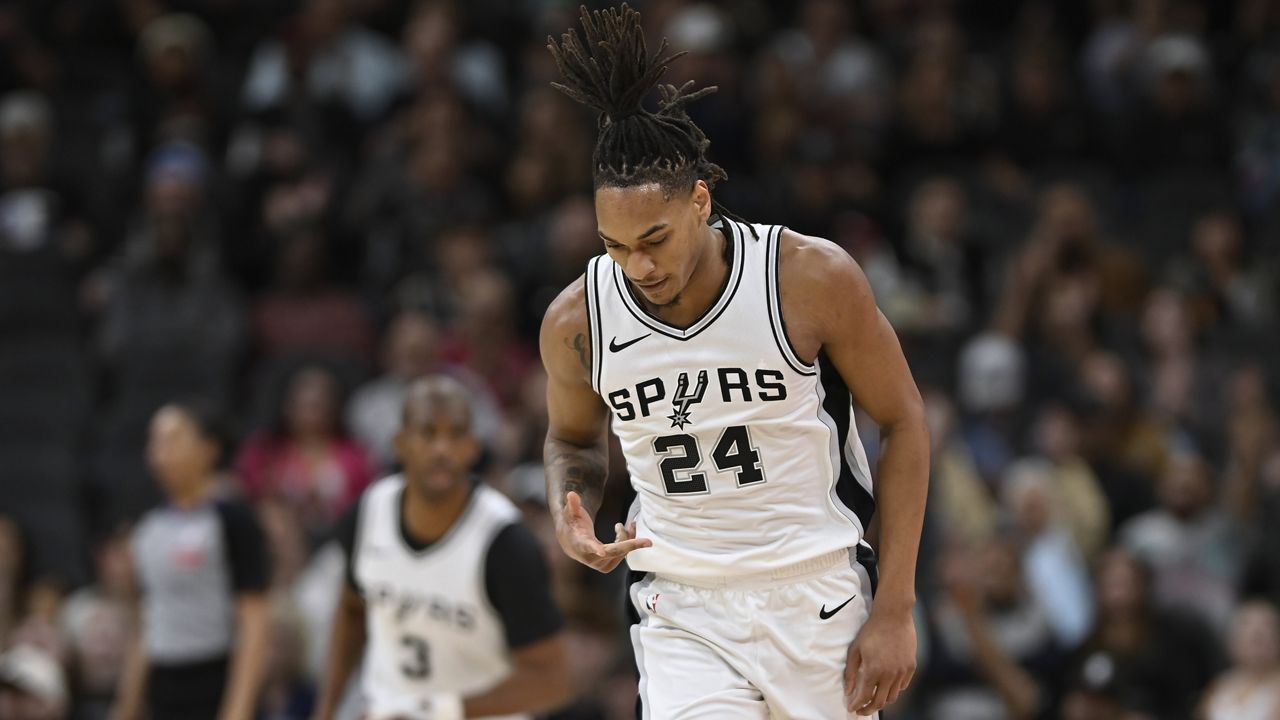 San Antonio Spurs guard Devin Vassell (24) celebrates a 3-point basket during the first half of an NBA basketball game against the Brooklyn Nets, Tuesday, March 4, 2025, in San Antonio. (AP Photo/Darren Abate)