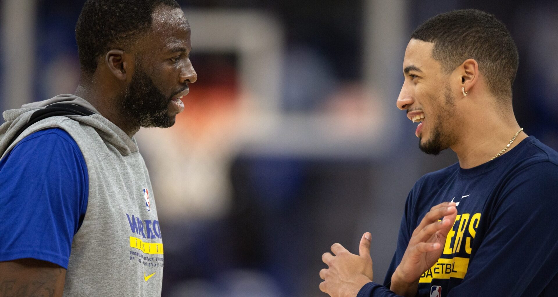 Golden State Warriors forward Draymond Green (23) and Indiana Pacers guard Tyrese Haliburton (0) chat before a game at Chase Center.