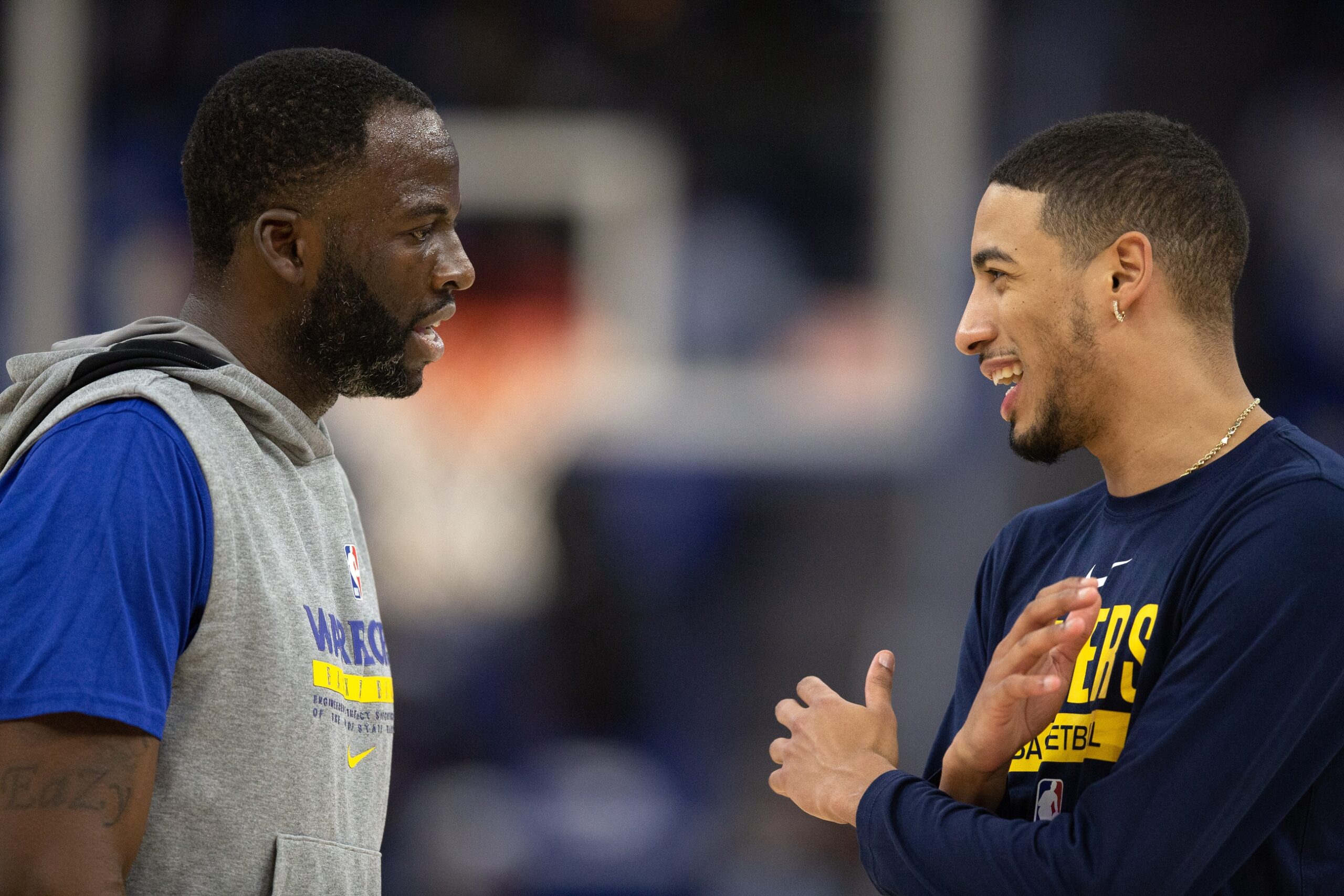 Golden State Warriors forward Draymond Green (23) and Indiana Pacers guard Tyrese Haliburton (0) chat before a game at Chase Center.