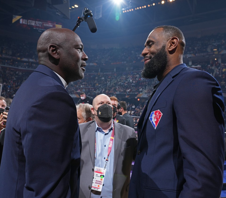 CLEVELAND, OH - FEBRUARY 20: NBA Legends, Michael Jordan and LeBron James shake hands during the 2022 NBA All-Star Game as part of 2022 NBA All Star Weekend on February 20, 2022 at Rocket Mortgage FieldHouse in Cleveland, Ohio. NOTE TO USER: User expressly acknowledges and agrees that, by downloading and/or using this Photograph, user is consenting to the terms and conditions of the Getty Images License Agreement. Mandatory Copyright Notice: Copyright 2022 NBAE (Photo by Jesse D. Garrabrant/NBAE via Getty Images)