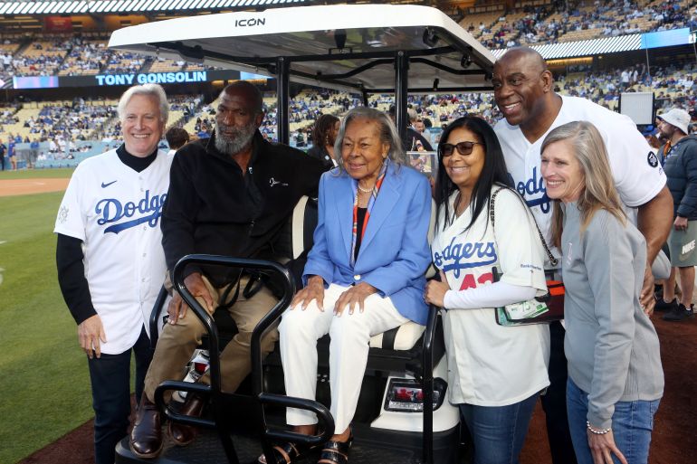 Mark Walter and Earvin 'Magic' Johnson react.