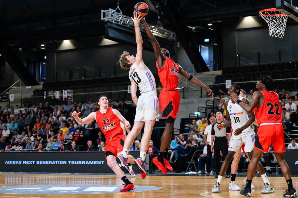 Szymon Nowicki, #13 of U18 Real Madrid and Mohamed Diawara, #21 of U18 Next Generation Select Team in action