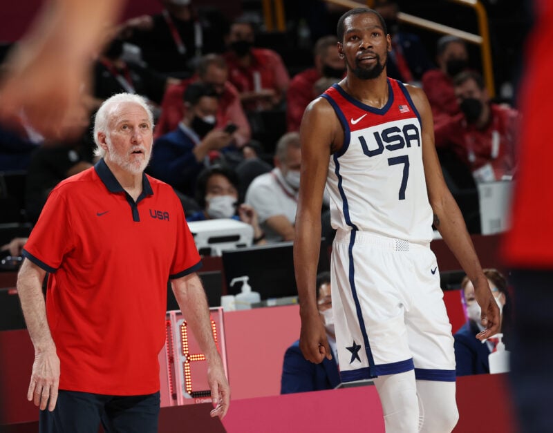 Team USA head coach Gregg Popovich stands next to forward Kevin Durant at the 2020 Olympics