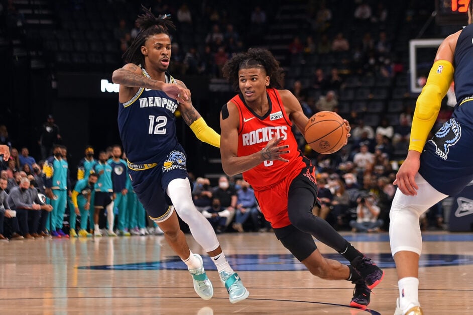 Ja Morant of the Memphis Grizzlies tries to contain Houston Rockets' Jalen Green on the court.
