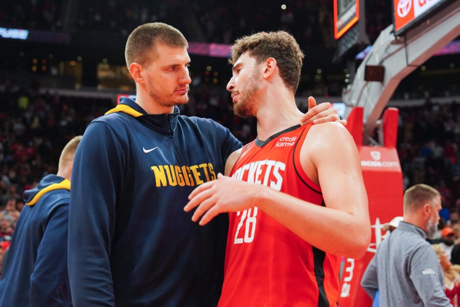 Denver Nuggets' Nikola Jokic places his hands on Houston Rockets' Alperen Sengun as the two stars talk.