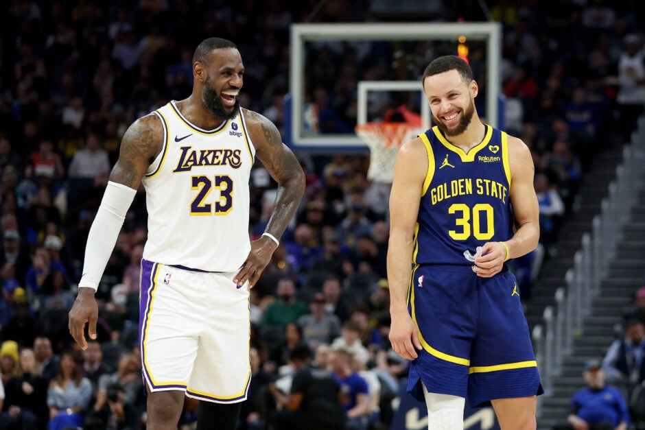 Stephen Curry #30 of the Golden State Warriors and LeBron James #23 of the Los Angeles Lakers joke around with one another during their game at Chase Center