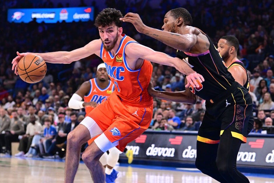 Chet Holmgren drives the ball while Kevin Durant guards him during a game between Phoenix Suns and the Oklahoma City Thunder