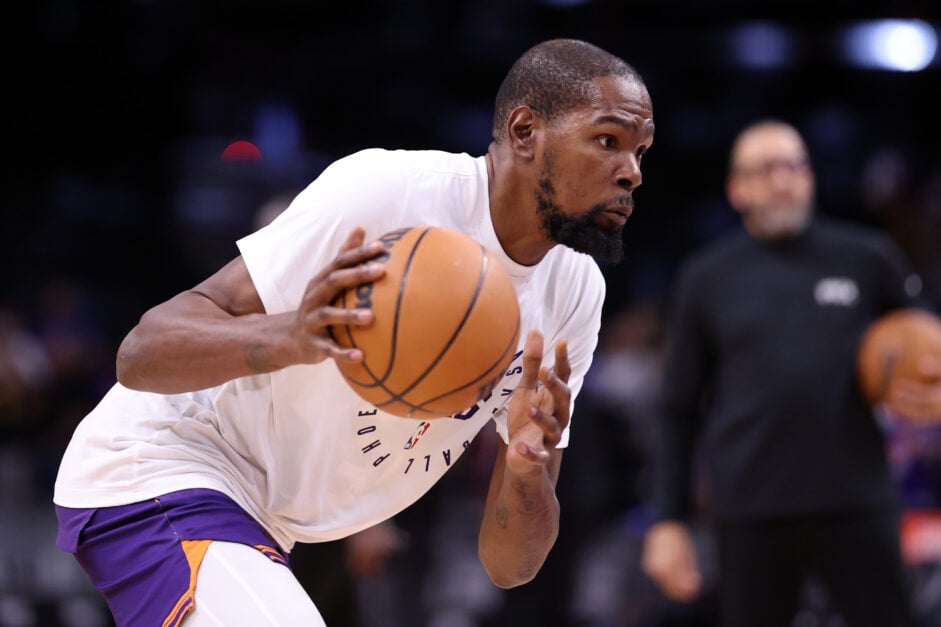 Kevin Durant dribbles the ball in a white shirt in warm-ups