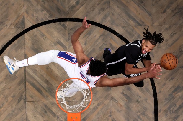 Ziaire Williams #8 of the Brooklyn Nets shoots the ball as Joel Embiid #21 of the Philadelphia 76ers defends during the second quarter at Barclays Center on January 04, 2025 in Brooklyn.