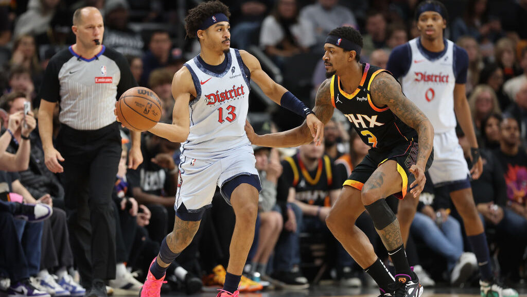 Jordan Poole #13 of the Washington Wizards handles the ball against Bradley Beal #3 of the Phoenix ...