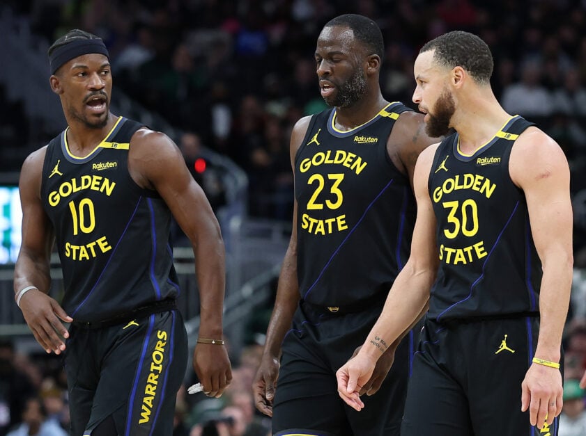 Jimmy Butler #10, Draymond Green #23 and Stephen Curry #30 of the Golden State Warriors walk backcourt during a game against the Milwaukee Bucks.